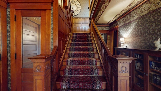 300 S Vine Ave, Marshfield, WI 54449 - stairway with wallpapered walls, ornamental molding, and a decorative wall