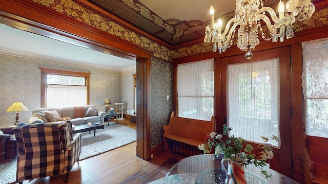 300 S Vine Ave, Marshfield, WI 54449 - dining room featuring hardwood / wood-style flooring, wallpapered walls, and a chandelier