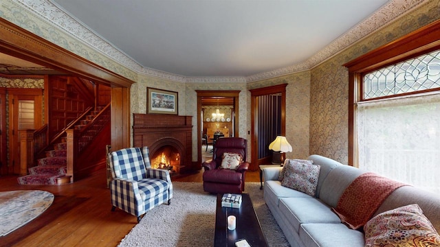 300 S Vine Ave, Marshfield, WI 54449 - living room with wood finished floors, wallpapered walls, a fireplace, and stairway