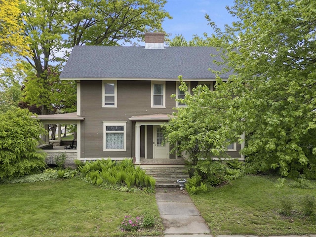 300 S Vine Ave, Marshfield, WI 54449 - american foursquare style home featuring a front lawn, a chimney, and roof with shingles