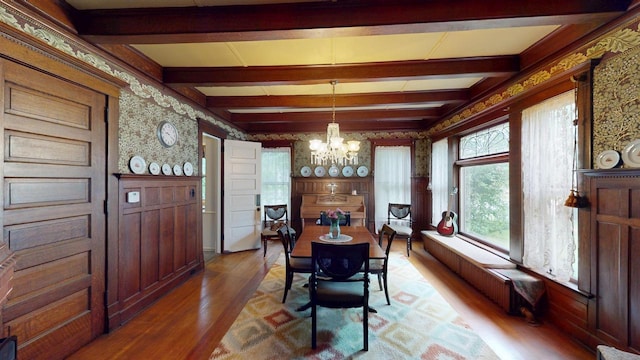 300 S Vine Ave, Marshfield, WI 54449 - dining room featuring wallpapered walls, light wood-style flooring, a chandelier, beamed ceiling, and radiator
