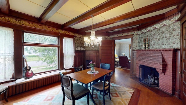 300 S Vine Ave, Marshfield, WI 54449 - dining room featuring wallpapered walls, wood finished floors, healthy amount of natural light, a wainscoted wall, and a chandelier