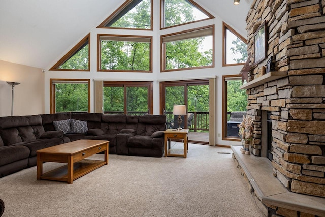 N1440 Red Oaks Dr, La Crosse, WI 54601 - carpeted living room with high vaulted ceiling, a stone fireplace, and healthy amount of natural light