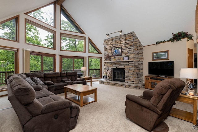 N1440 Red Oaks Dr, La Crosse, WI 54601 - carpeted living area with high vaulted ceiling, a stone fireplace, and healthy amount of natural light