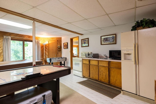 N1440 Red Oaks Dr, La Crosse, WI 54601 - game room featuring a drop ceiling, light floors, wood walls, and a sink