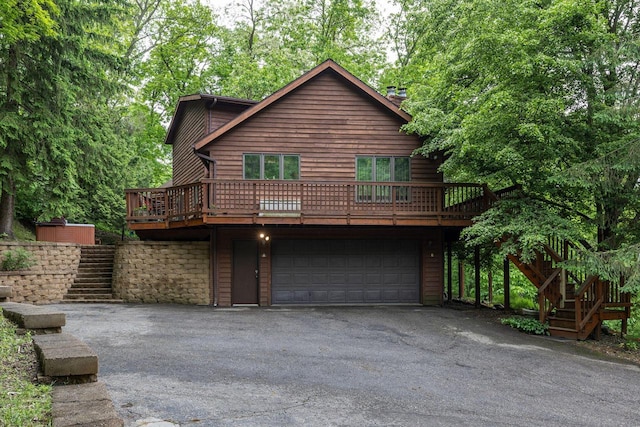 N1440 Red Oaks Dr, La Crosse, WI 54601 - chalet / cabin with stairway, driveway, an attached garage, and a deck