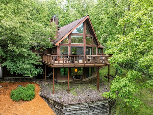 N1440 Red Oaks Dr, La Crosse, WI 54601 - rear view of property featuring a deck, a chimney, and a forest view