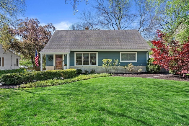 415 E Willow Rd, Fox Point, WI 53217 - view of front of property with roof with shingles, a front yard, stone siding, and a chimney