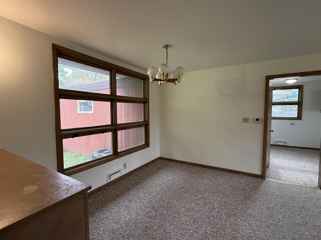 2617 Peck St, Stevens Point, WI 54481 - unfurnished dining area featuring carpet floors, a chandelier, and baseboards