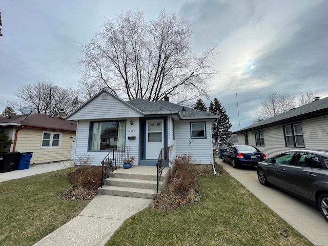 2209 Summit Ave, Racine, WI 53404 - bungalow-style home with a front yard and a shingled roof