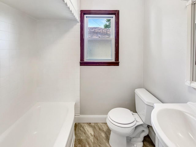 2209 Summit Ave, Racine, WI 53404 - bathroom featuring baseboards, toilet, and a sink