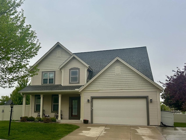 1712 Galena Dr, Port Washington, WI 53074 - traditional home with concrete driveway, covered porch, a garage, and roof with shingles
