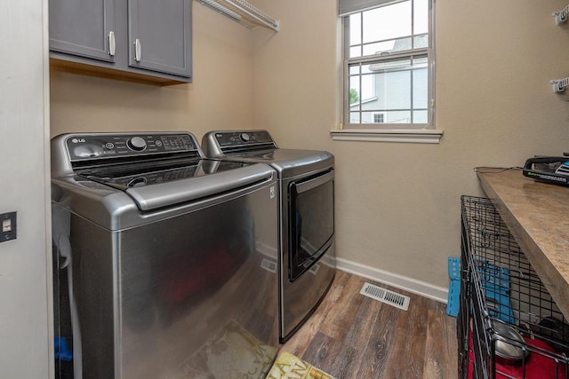 1712 Galena Dr, Port Washington, WI 53074 - laundry room featuring cabinet space, dark wood-style flooring, separate washer and dryer, and baseboards