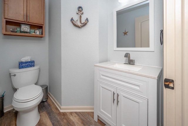 1712 Galena Dr, Port Washington, WI 53074 - bathroom featuring wood finished floors, vanity, toilet, and baseboards