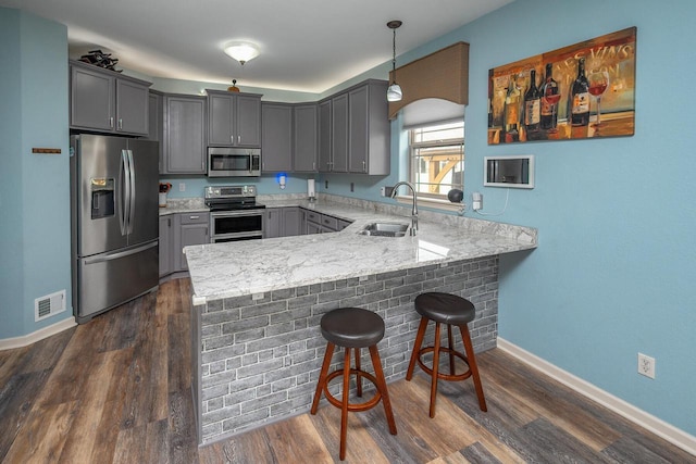1712 Galena Dr, Port Washington, WI 53074 - kitchen featuring appliances with stainless steel finishes, a sink, gray cabinets, a peninsula, and baseboards