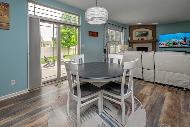 1712 Galena Dr, Port Washington, WI 53074 - dining space featuring wood finished floors, a fireplace, and baseboards
