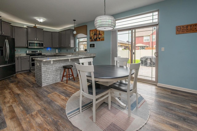 1712 Galena Dr, Port Washington, WI 53074 - dining room featuring plenty of natural light, dark wood-style flooring, and baseboards