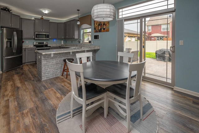 1712 Galena Dr, Port Washington, WI 53074 - dining area featuring dark wood-style floors, healthy amount of natural light, and baseboards