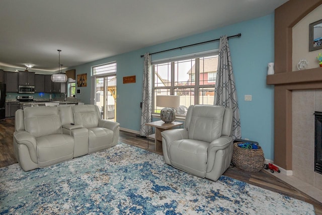 1712 Galena Dr, Port Washington, WI 53074 - living room with wood finished floors, baseboards, and a tiled fireplace