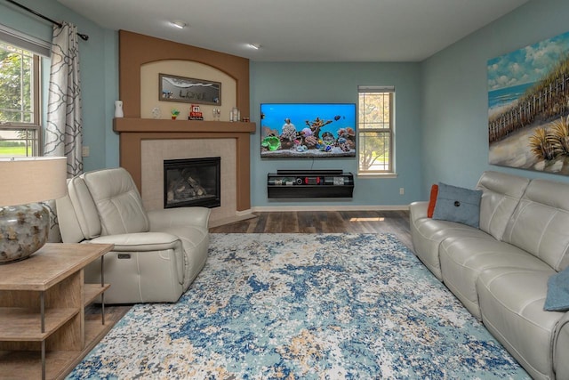 1712 Galena Dr, Port Washington, WI 53074 - living area featuring wood finished floors, a tiled fireplace, and baseboards
