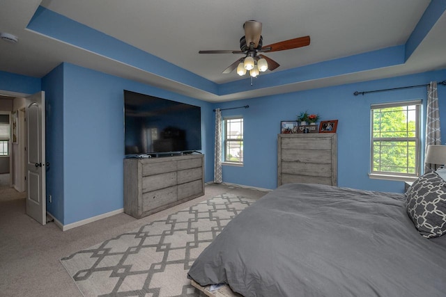 1712 Galena Dr, Port Washington, WI 53074 - bedroom featuring a tray ceiling, baseboards, multiple windows, and carpet floors