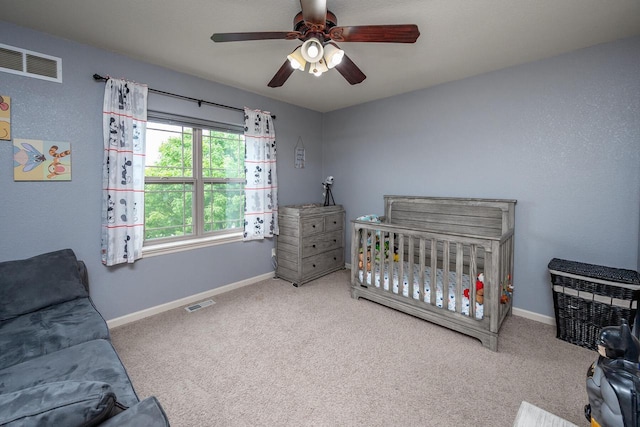 1712 Galena Dr, Port Washington, WI 53074 - carpeted bedroom with baseboards, a crib, and a ceiling fan