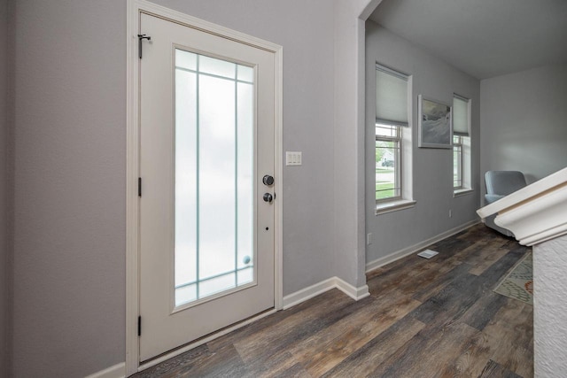 1712 Galena Dr, Port Washington, WI 53074 - foyer featuring dark wood finished floors, baseboards, and arched walkways