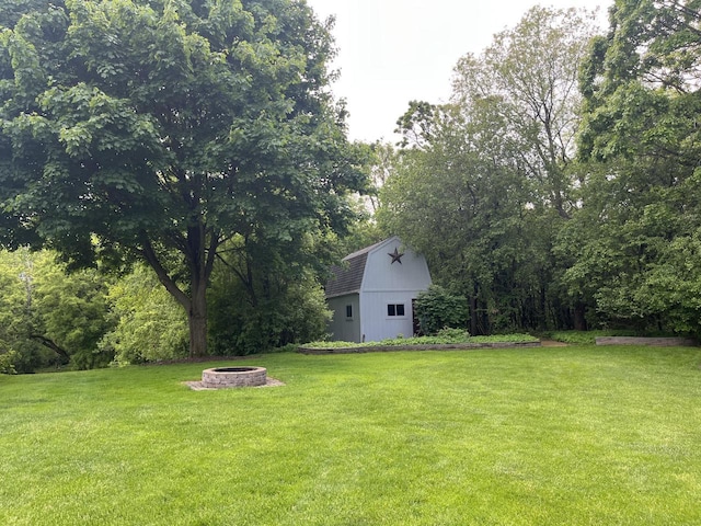 936 Broken Bow Ct, Delafield, WI 53018 - view of grassy yard with a fire pit, a barn, and an outdoor structure