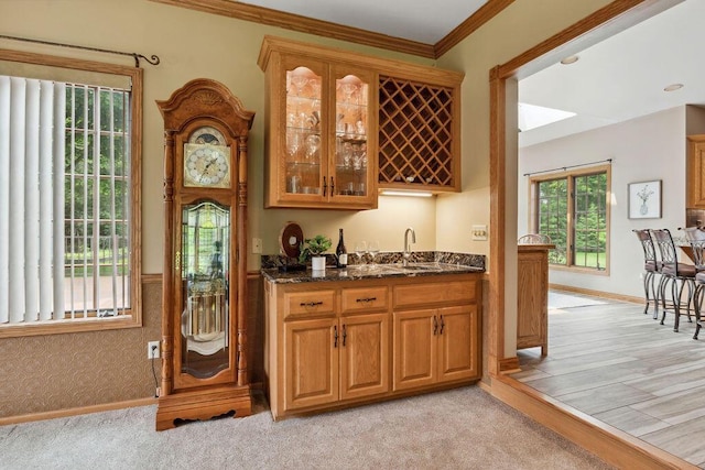 936 Broken Bow Ct, Delafield, WI 53018 - indoor wet bar with crown molding, baseboards, and light colored carpet