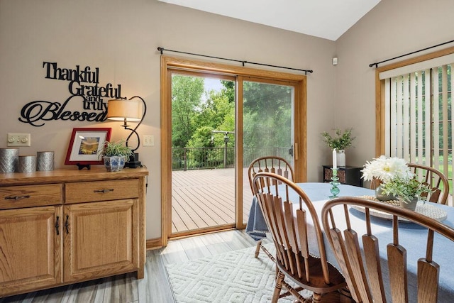 936 Broken Bow Ct, Delafield, WI 53018 - dining space featuring vaulted ceiling and light wood-style flooring