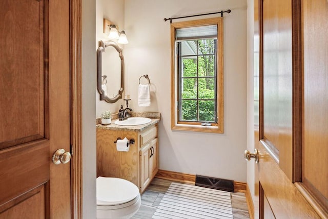 936 Broken Bow Ct, Delafield, WI 53018 - bathroom with vanity, toilet, and baseboards