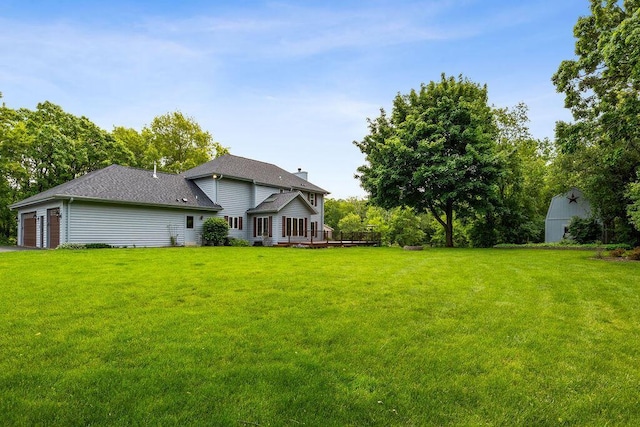 936 Broken Bow Ct, Delafield, WI 53018 - view of green lawn with a wooden deck and an attached garage