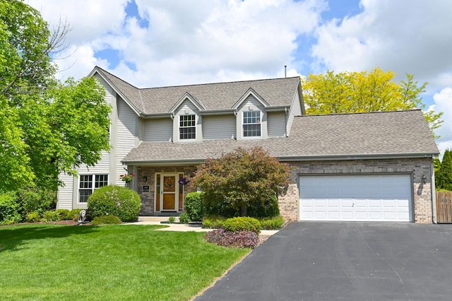 N66W13568 Crestwood Dr, Menomonee Falls, WI 53051 - traditional-style house with asphalt driveway, roof with shingles, a front lawn, and a garage