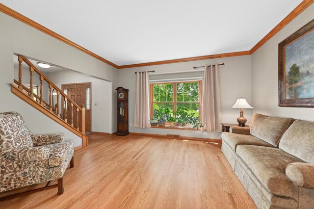 N66W13568 Crestwood Dr, Menomonee Falls, WI 53051 - living area featuring wood finished floors, ornamental molding, stairs, and baseboards