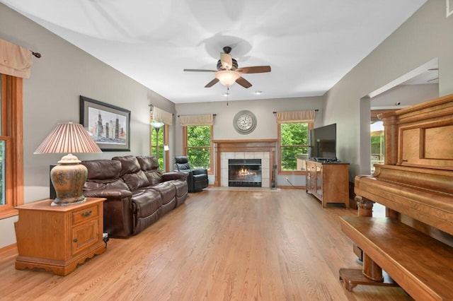 N66W13568 Crestwood Dr, Menomonee Falls, WI 53051 - living room with light wood-style flooring, ceiling fan, and a tile fireplace