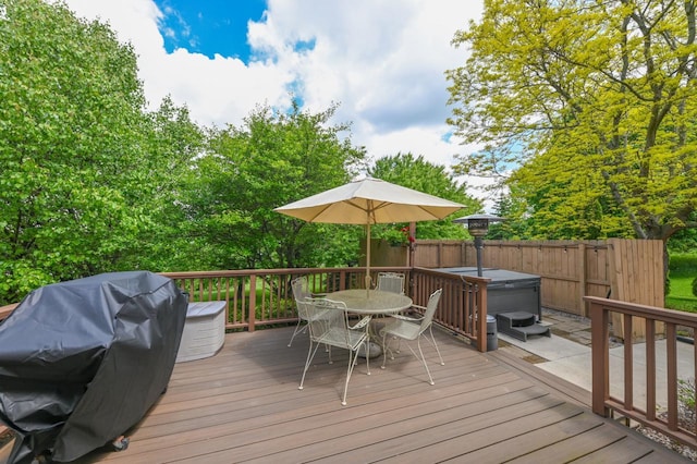 N66W13568 Crestwood Dr, Menomonee Falls, WI 53051 - wooden deck featuring a hot tub, outdoor dining space, and area for grilling