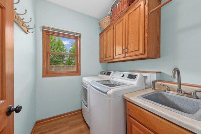 N66W13568 Crestwood Dr, Menomonee Falls, WI 53051 - laundry room with independent washer and dryer, cabinet space, light wood finished floors, and baseboards