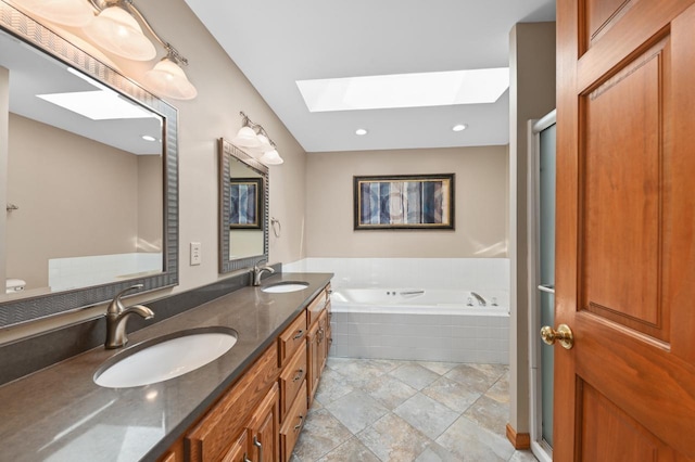 N66W13568 Crestwood Dr, Menomonee Falls, WI 53051 - full bathroom with a skylight, a bath, double vanity, stone finish flooring, and recessed lighting