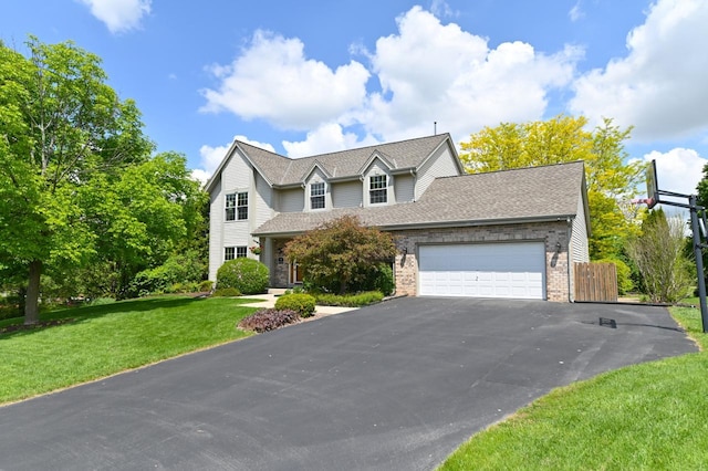 N66W13568 Crestwood Dr, Menomonee Falls, WI 53051 - traditional-style house featuring a garage, driveway, brick siding, a front lawn, and roof with shingles
