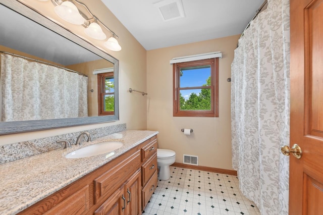 N66W13568 Crestwood Dr, Menomonee Falls, WI 53051 - bathroom featuring vanity, healthy amount of natural light, toilet, and baseboards