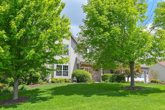N66W13568 Crestwood Dr, Menomonee Falls, WI 53051 - obstructed view of property featuring a front lawn