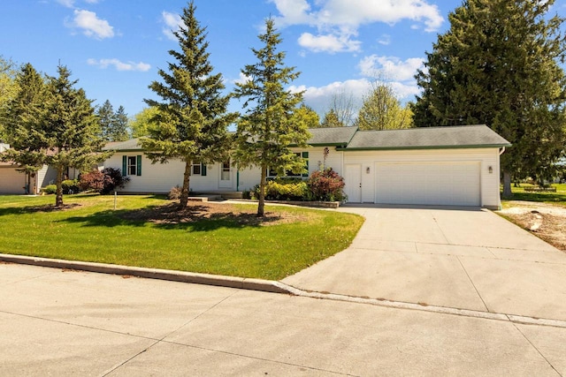 2225 Paul Rd, Manitowoc, WI 54220 - view of front of house with concrete driveway, an attached garage, and a front lawn