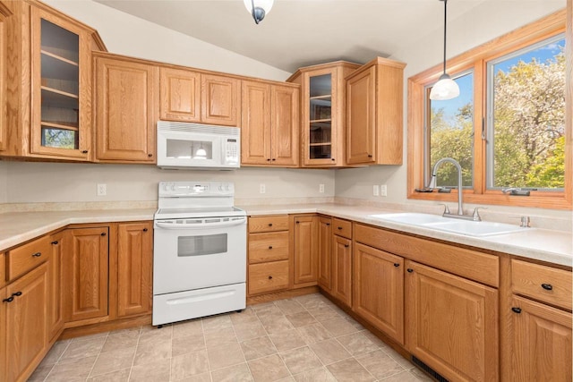 2225 Paul Rd, Manitowoc, WI 54220 - kitchen featuring white appliances, vaulted ceiling, a sink, pendant lighting, and light countertops