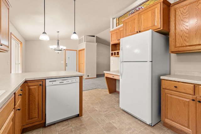 2225 Paul Rd, Manitowoc, WI 54220 - kitchen featuring white appliances, light countertops, a chandelier, and decorative light fixtures