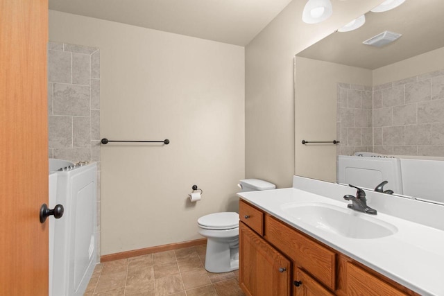 2225 Paul Rd, Manitowoc, WI 54220 - full bath featuring a bath, vanity, toilet, baseboards, and tile patterned floors