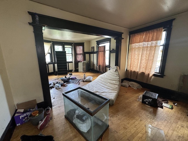 2877 N 23rd St Unit 2879, Milwaukee, WI 53206 - living room featuring hardwood / wood-style flooring, baseboards, and ornate columns