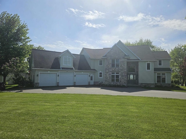 N2281 Lakewood Ln, Chilton, WI 53014 - view of front of property with asphalt driveway, a front lawn, stone siding, and a garage