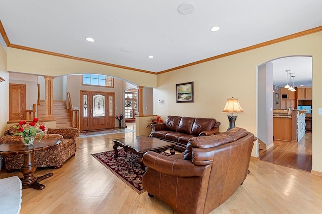 N2281 Lakewood Ln, Chilton, WI 53014 - living room featuring arched walkways, light wood-type flooring, recessed lighting, crown molding, and ornate columns