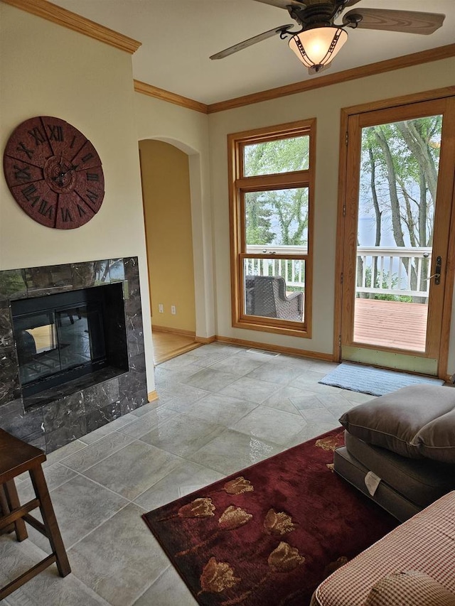 N2281 Lakewood Ln, Chilton, WI 53014 - living area with ornamental molding, arched walkways, ceiling fan, baseboards, and a high end fireplace