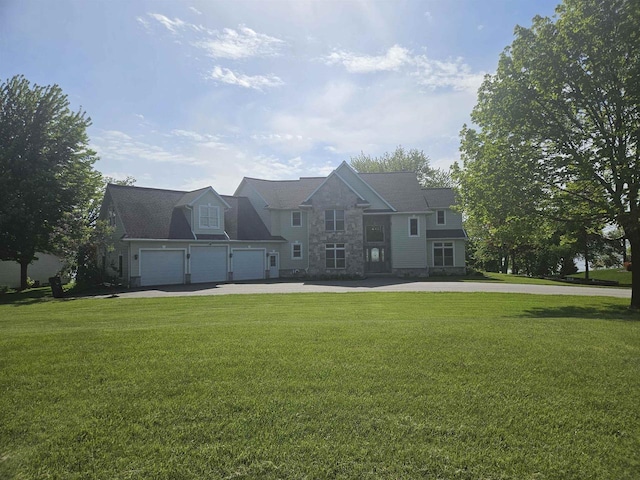 N2281 Lakewood Ln, Chilton, WI 53014 - view of front facade with driveway, a front lawn, stone siding, and a garage